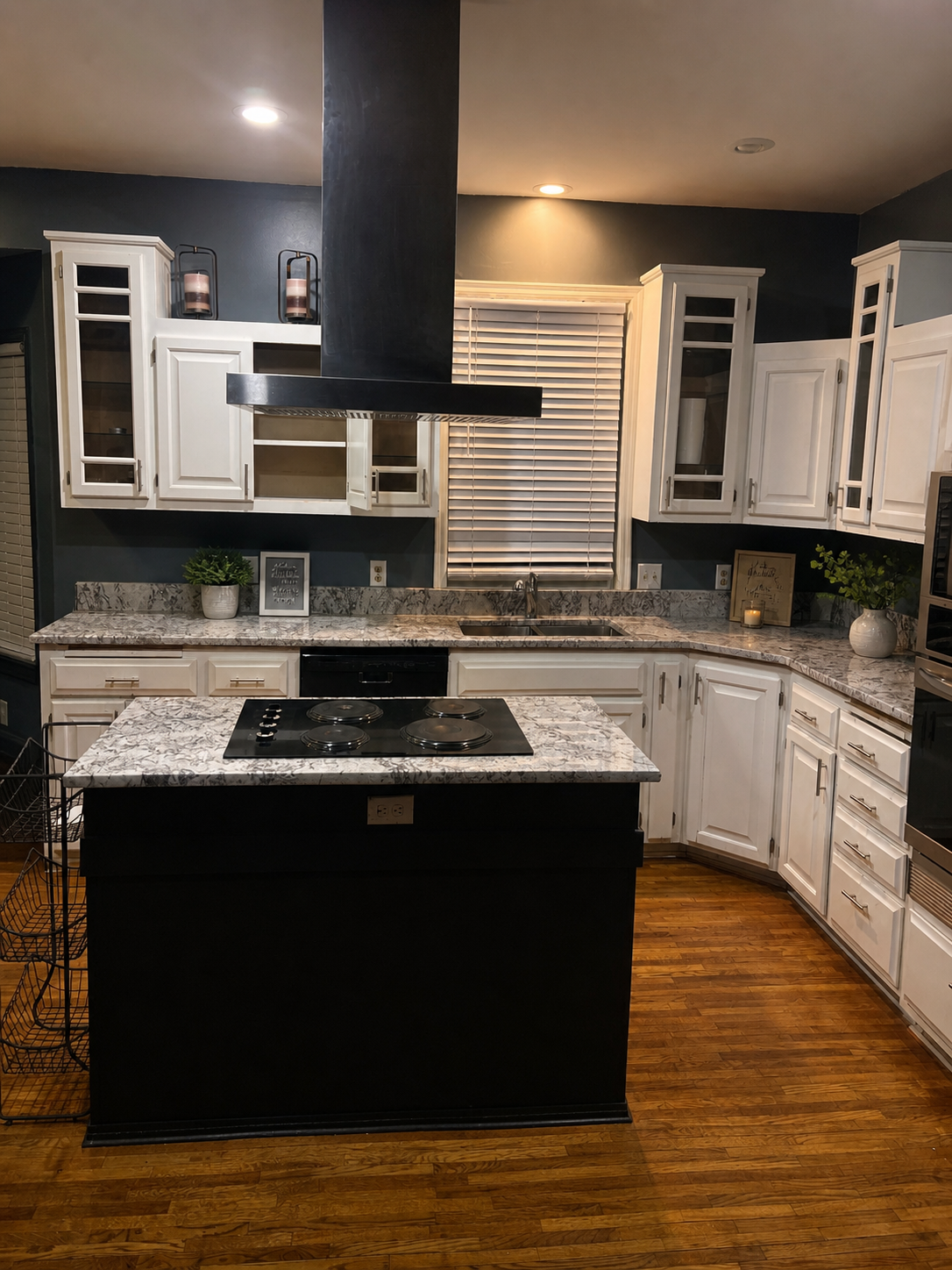 Sygma House kitchen — granite counters, island, hardwood floors